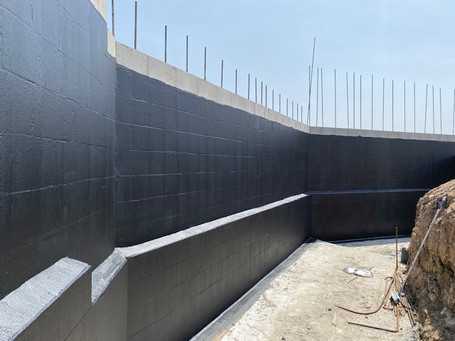 Applying Waterproofing Membrane to Retaining Wall