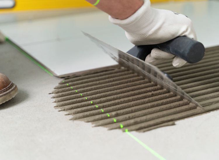 Tiling contractor installing tiles during a renovation project