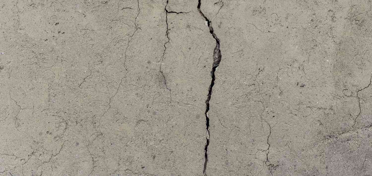 Close-up of a concrete crack with visible fissures